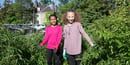 Two tween girls work together in an urban garden.